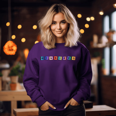 Introducing our newest addition to your wardrobe - the trendy graphic sweatshirt featuring colorful Winnipeg Scrabble Titles.